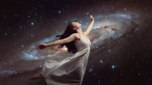 una mujer con los brazos abiertos conectada con el universo y la paz interior